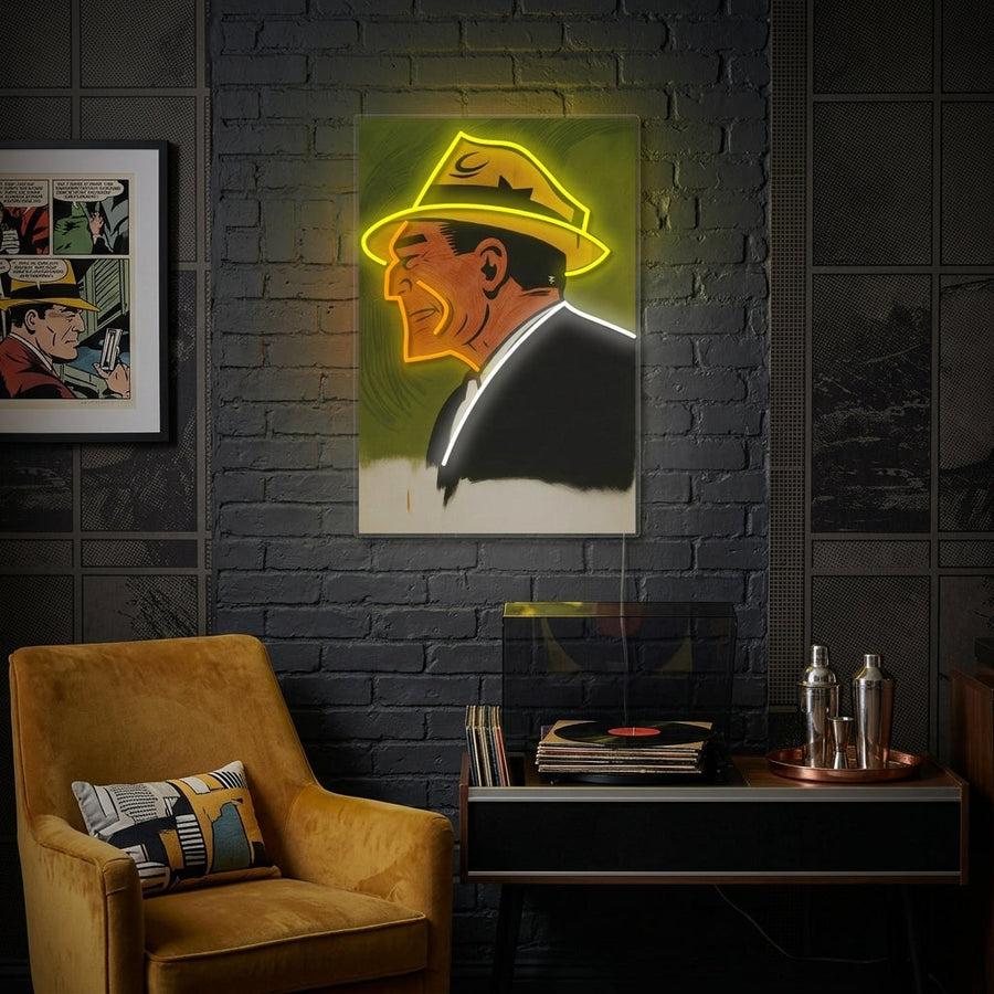 A glowing blue and orange 'Comic Mob Boss' graphic neon sign hanging as wall decor in a modern, stylized room.