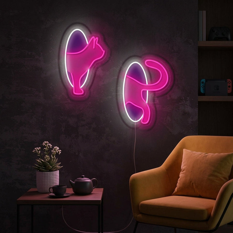 A cozy, modern living room mockup featuring the illuminated Cat in Portal neon sign on a textured wall, surrounded by plants and bookshelves.