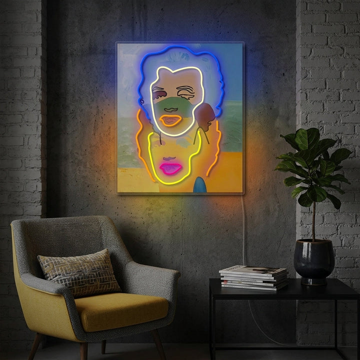 A stylish room interior featuring the illuminated 'Double Portrait' neon sign glowing on a textured wall above a plush sofa and modern decor, creating a trendy ambiance.