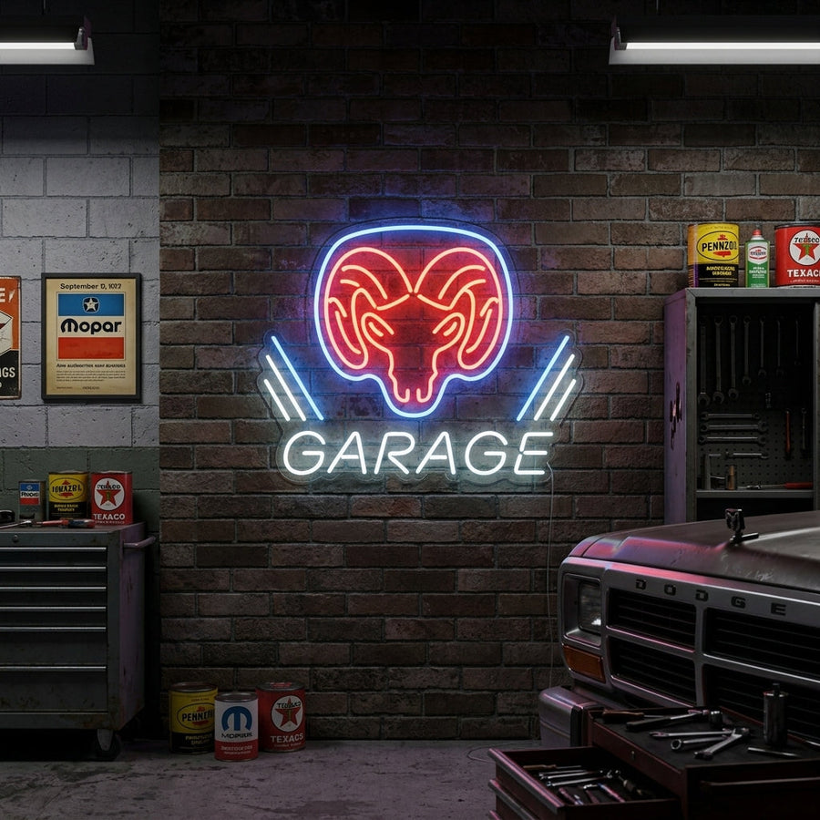 A lifestyle mockup showing the Dodge Ram Garage neon sign lit up and hanging on a rustic brick wall within a car enthusiast's garage setup, surrounded by tools and equipment.