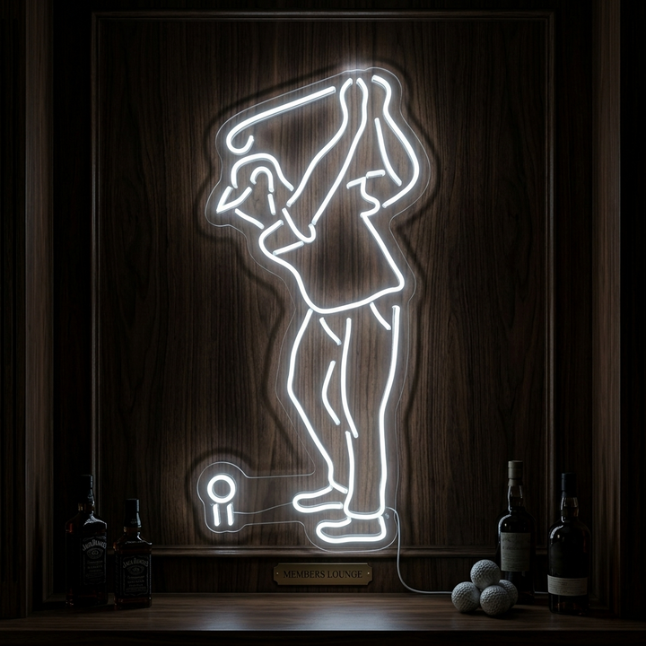 A close-up photograph of a physical neon sign showing a golfer in full swing, mounted on a clear acrylic backboard with visible tubes and wiring, glowing brightly against a dark, industrial background.