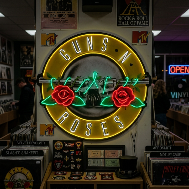 Guns N' Roses neon sign displaying the band's roses and revolvers logo glowing in yellow, red, and blue colors, hanging on a wall in a record store filled with vinyl and posters.