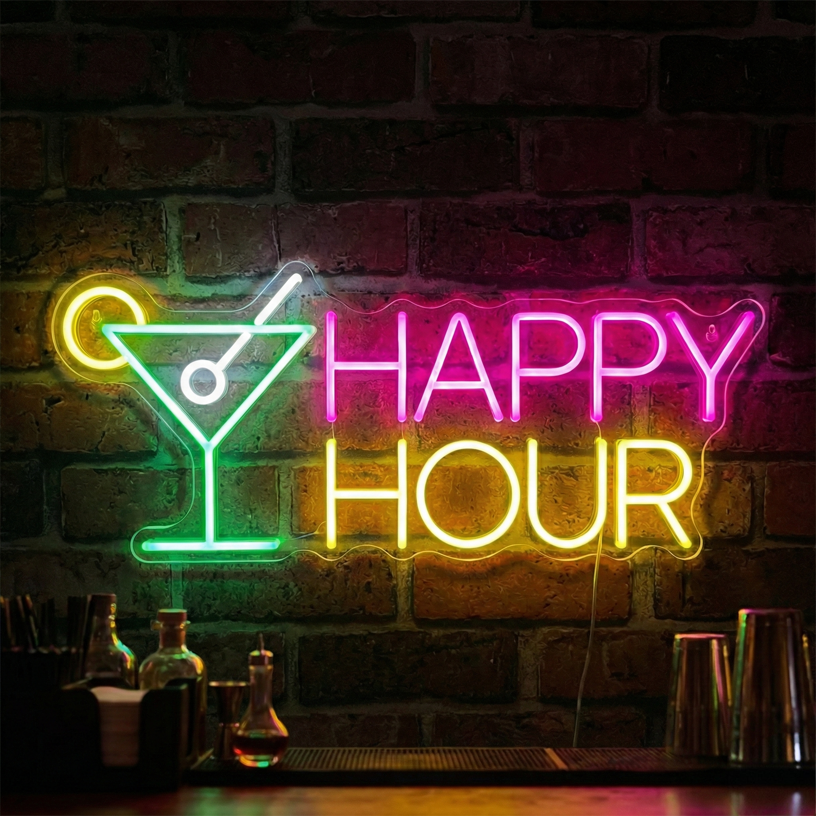 A glowing 'Happy Hour' neon sign featuring red and blue script above stylized cocktail and wine glass graphics, illuminated against a rustic brick wall behind a bar with liquor bottles and plants.