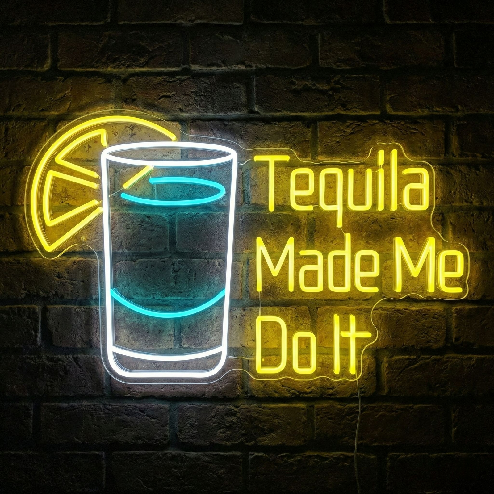 The 'Tequila Made Me Do It' neon sign glowing brightly on a brick wall, featuring distinct physical tubes and a clear acrylic backer.