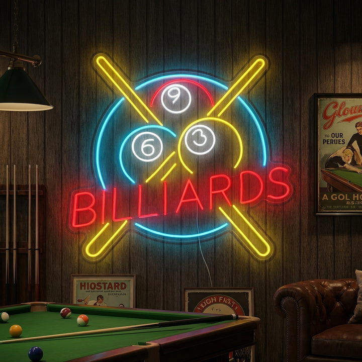 A vibrant Billiards neon sign glowing blue and red on a textured wall above a pool table and chairs.