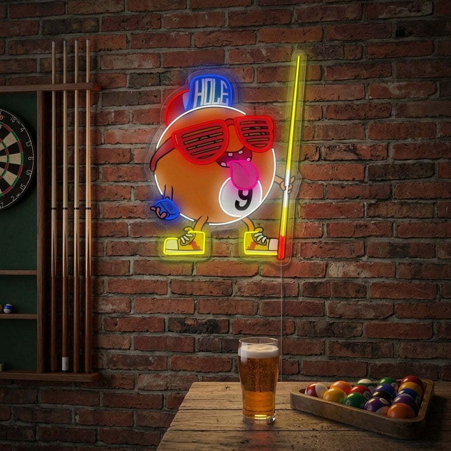 A lifestyle shot of the Billiard Nine Ball neon sign glowing brightly on the wall of a cozy home game room above a pool table.
