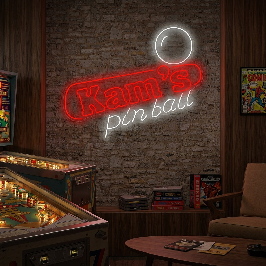 A custom Pinball neon sign glowing red, saying 'Custom Name Pinball' with an illuminated flipper and ball design, hanging above a pinball machine in a home arcade.