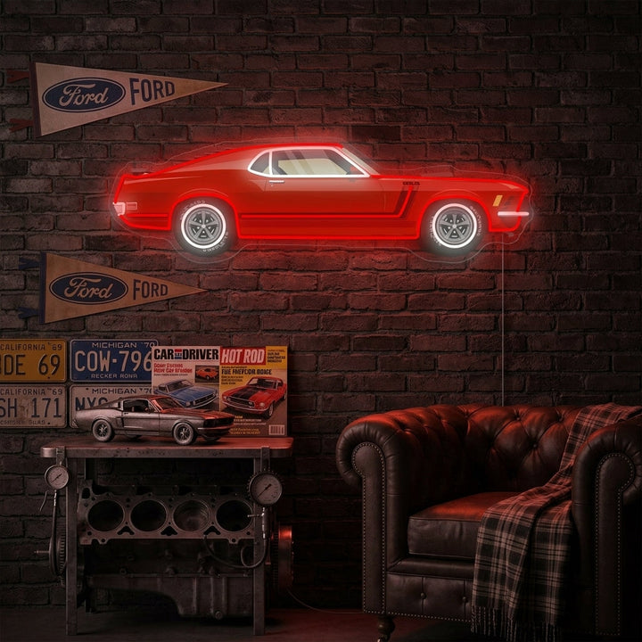 American Muscle Car neon sign glowing blue on a garage wall above tools.