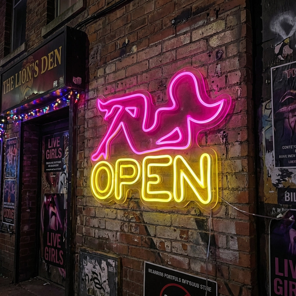 A physical "Strip Club" neon sign with glowing pink tubing and individual LED dots on a exposed brick wall background.