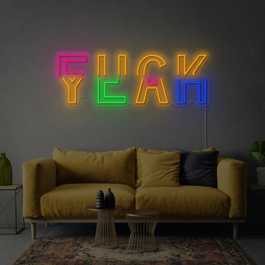 A lifestyle mockup showing the glowing 'Fuck Yeah' neon sign displayed on a stylish room wall.