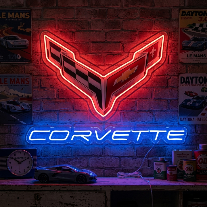 A real physical red glowing neon sign shaped like the vintage Corvette script logo, mounted on a garage wall above tools.