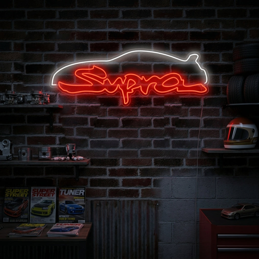 Supra script neon sign glowing in a garage workshop setting above a motorcycle