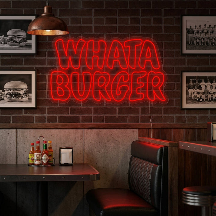 A Whataburger neon sign hanging on a wall in a brightly lit modern living room or hangout area, showcasing its glow in a lifestyle setting.