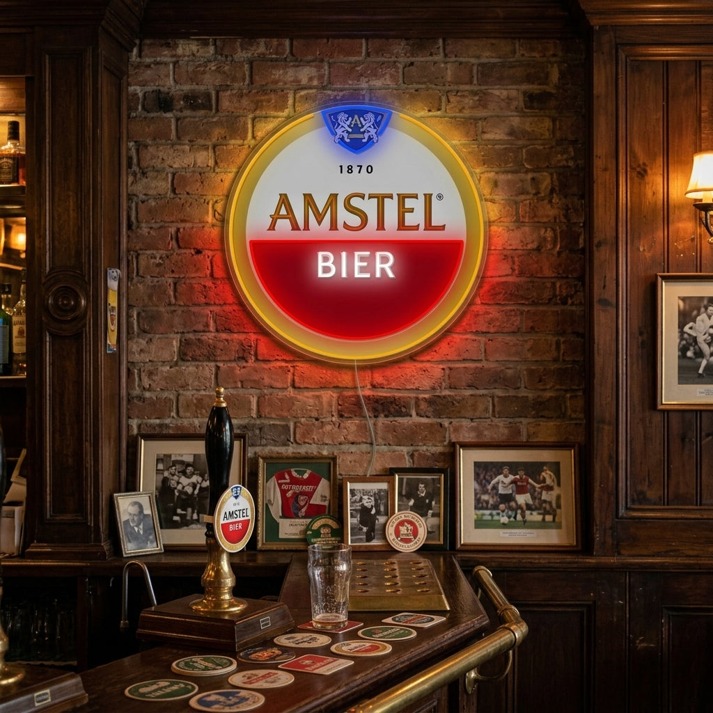 A vibrant Amstel Logo neon sign displayed above a polished wooden home bar, casting a warm glow in a cozy room setting.