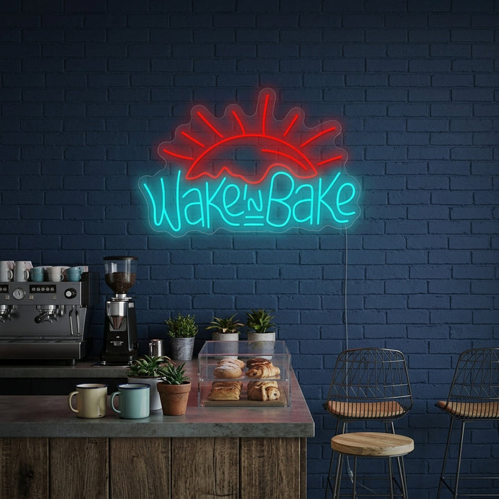 A lifestyle mockup of the "Wake and Bake" neon sign illuminating a modern kitchen or bakery wall.