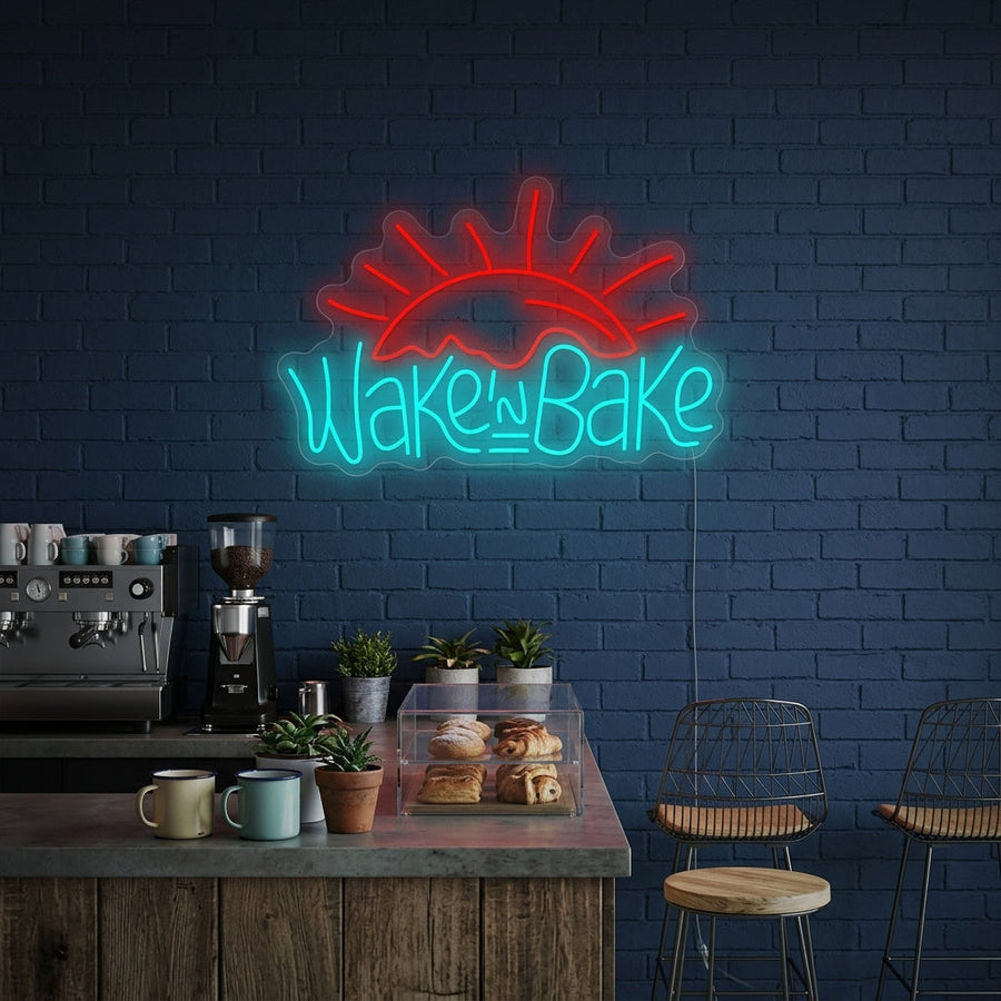 A lifestyle mockup of the "Wake and Bake" neon sign illuminating a modern kitchen or bakery wall.