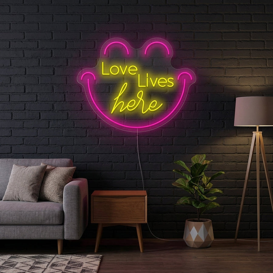 A heartwarming "Love Live Here" script neon sign glowing over a contemporary sofa and cozy home decor.