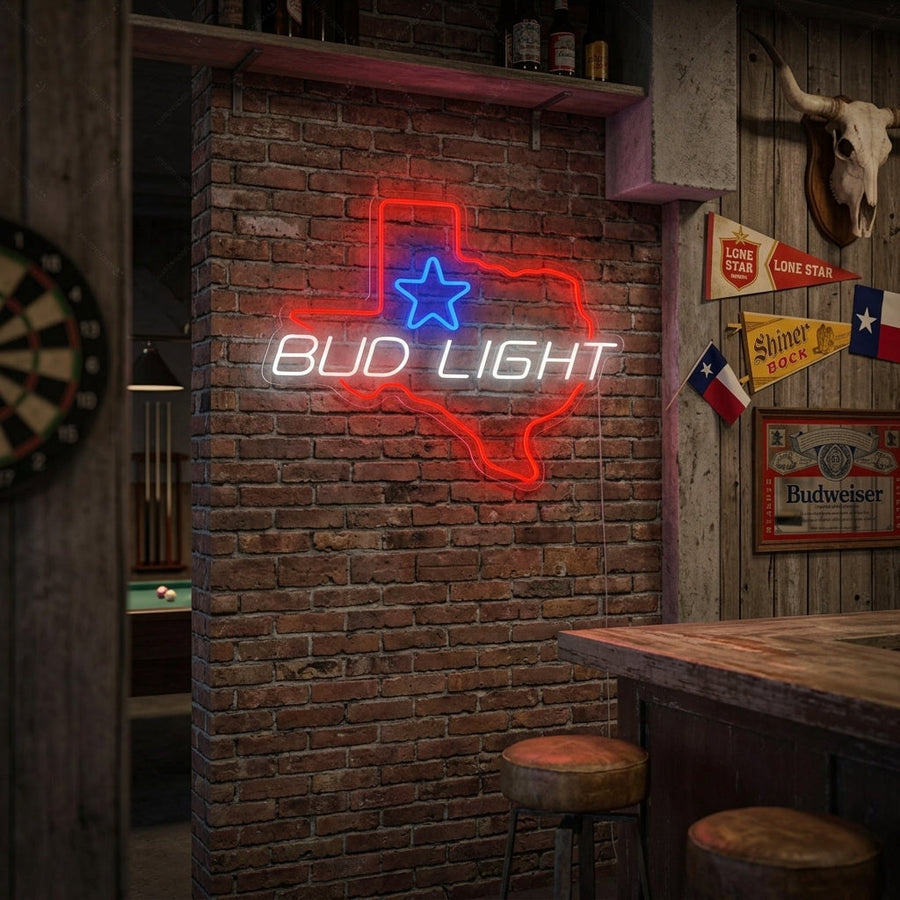 A vibrant 'Bud Light Texas Star' neon sign glowing on a textured brick wall in a cozy home bar setting, illuminating a glass of beer nearby.