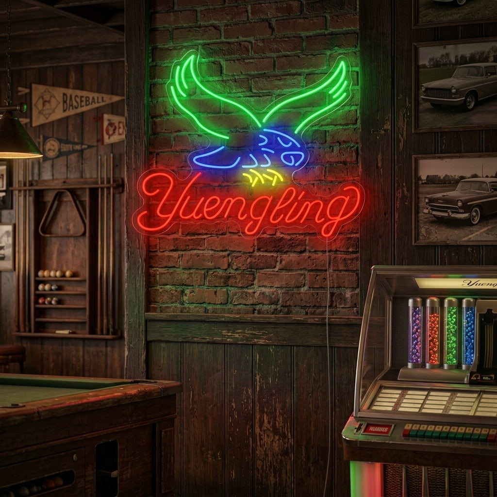 A glowing Yuengling neon sign mounted on a dark brick wall above a well-stocked home bar.