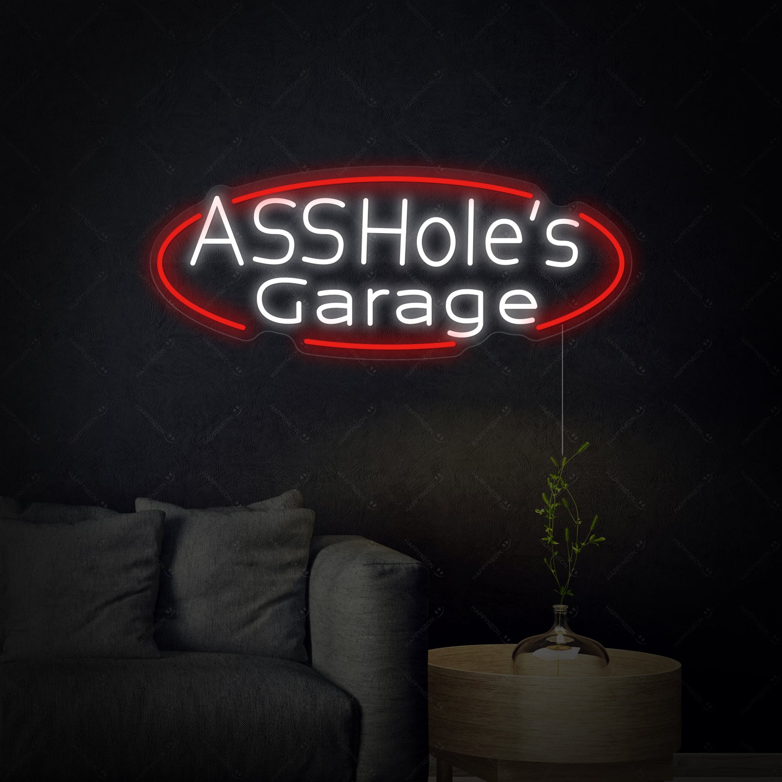A close-up view of the 'Assholes Garage' neon sign glowing brightly on a wall.