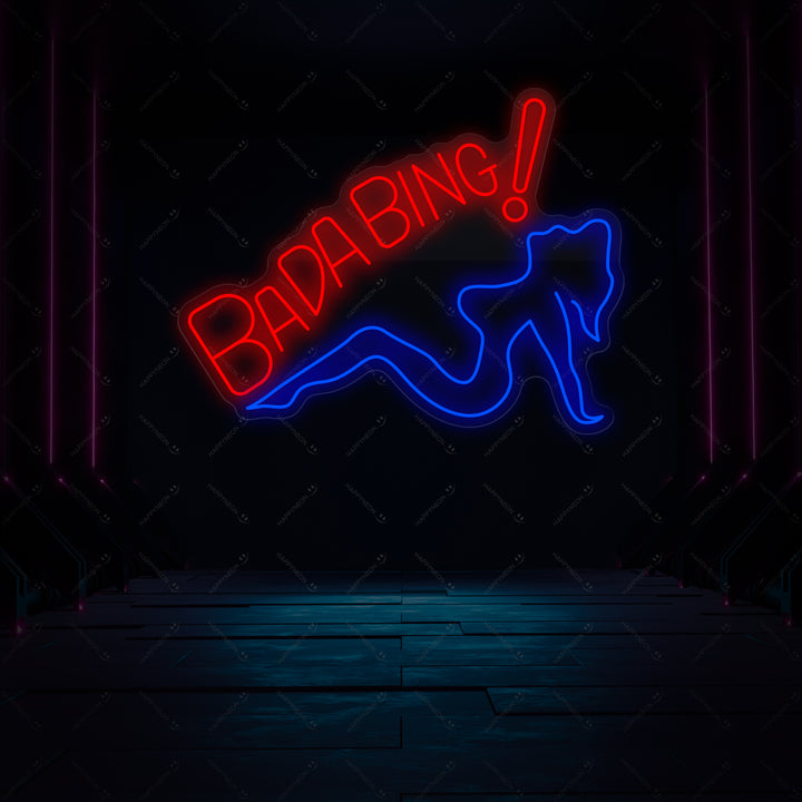A glowing blue 'Bada Bing' neon wall sign graphic illuminated on a dark grey brick wall in a modern, stylish lounge setting.