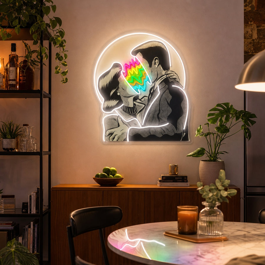 Modern artistic UV print neon sign depicting a kissing couple with vibrant blue, yellow, and red glow effects mounted on a patterned wall.