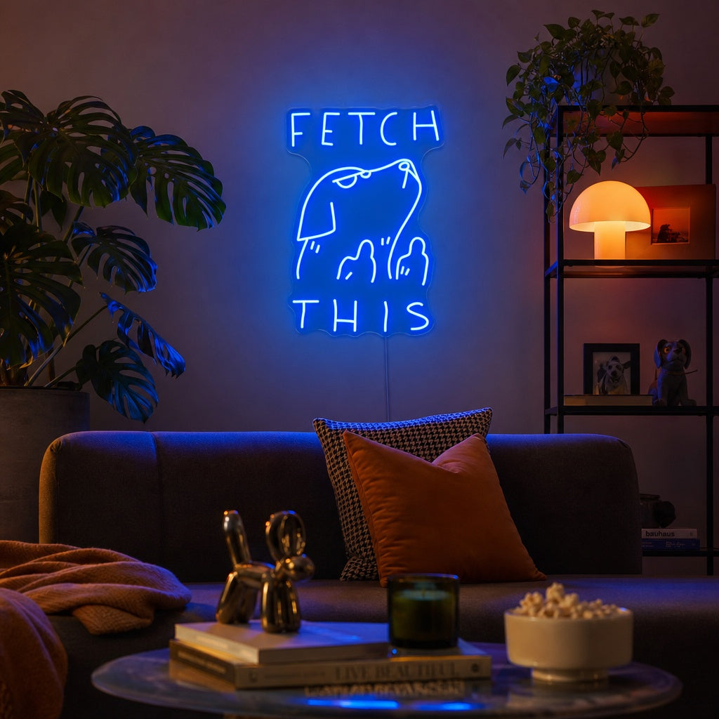 A glowing 'Fetch This' neon sign featuring an arcade-style dog catching a bone graphic, mounted in a modern living room setting.