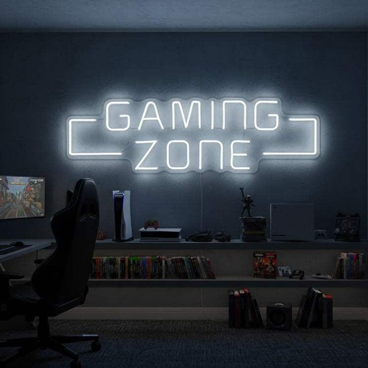 A 'Game Zone' neon sign glowing red and blue above a multi-monitor gaming desk setup in a dimly lit room.
