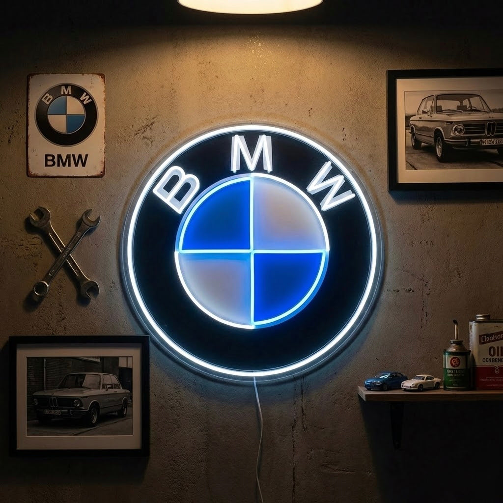 A vibrant German performance car neon sign glowing red, white, and blue mounted in a clean, modern garage environment.