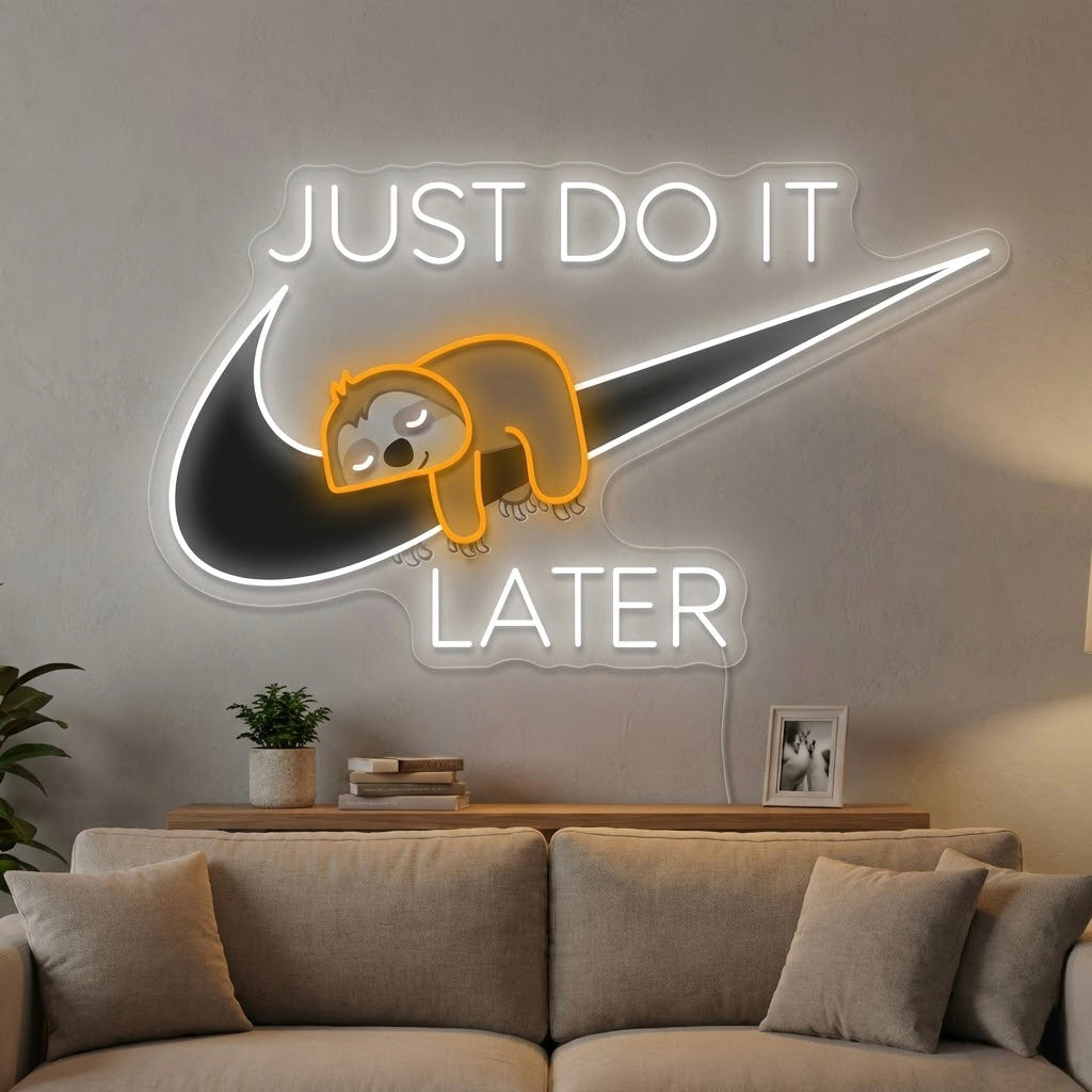 A Just Do It Later Sloth UV Print Neon Sign featuring a detailed sloth design and the glowing text 'Just Do It Later' on an acrylic backplate, hanging on a rustic brick wall.