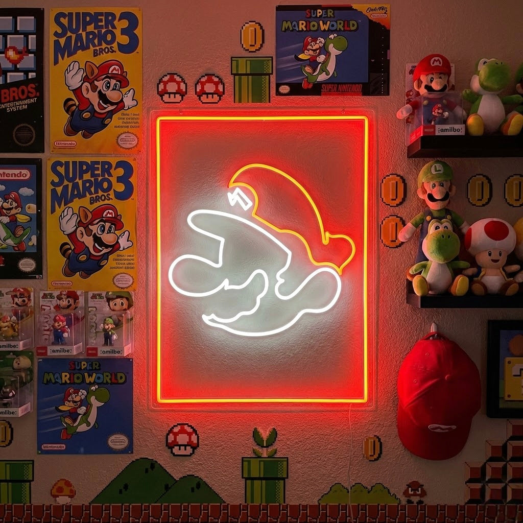 A glowing blue and yellow Super Game Room neon sign mounted on a textured brick wall, illuminated above a desk filled with gaming gear, posters, and collectibles in a decorated game room setup.