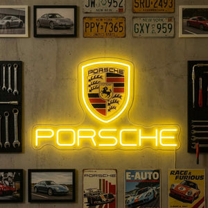 Neon Porsche logo on a wall with automotive-themed decorations