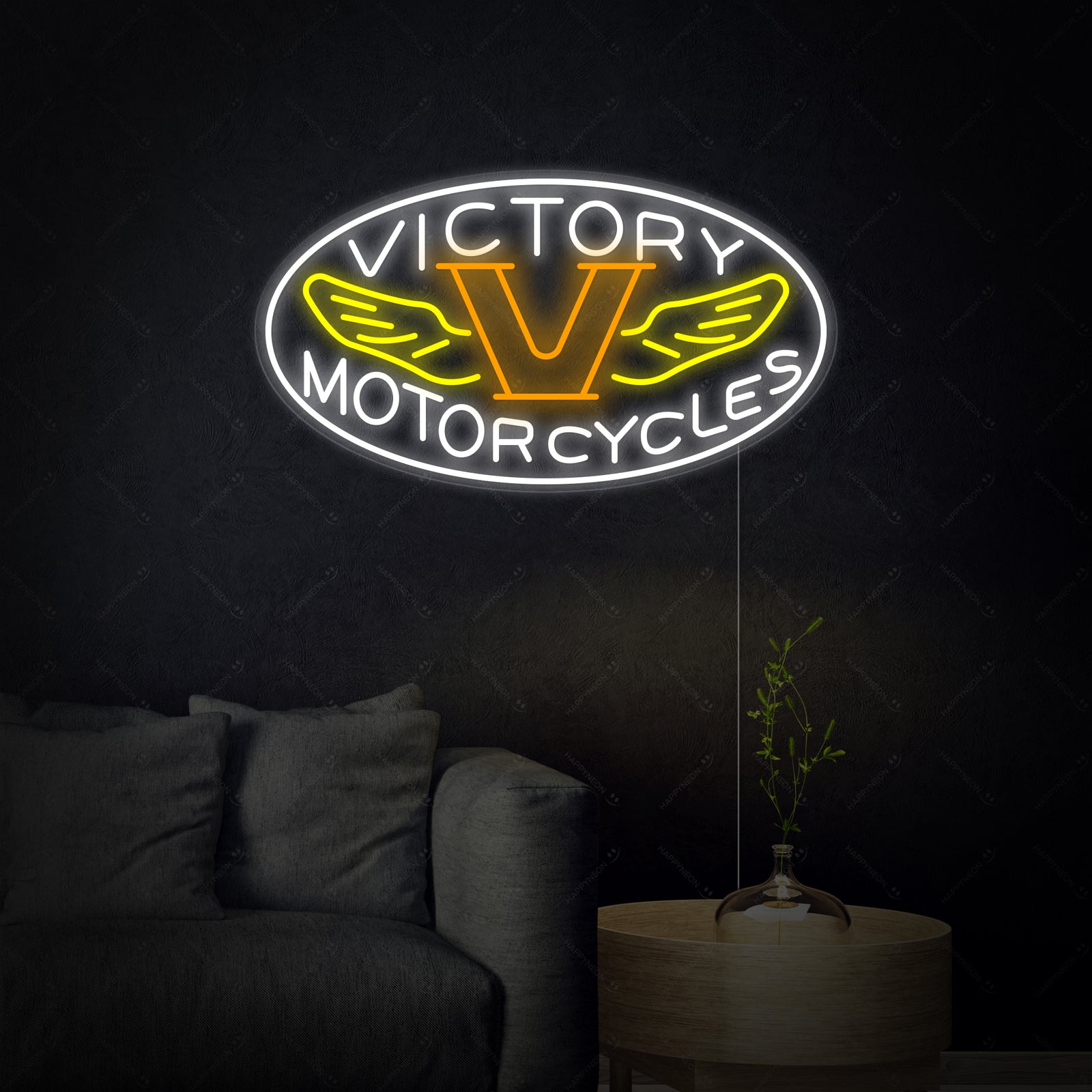 A close-up view of the 'Motorcycles Victory' neon sign, showing the detailed blue and red neon tubes mounted on a clear backer, with subtle wiring details visible.