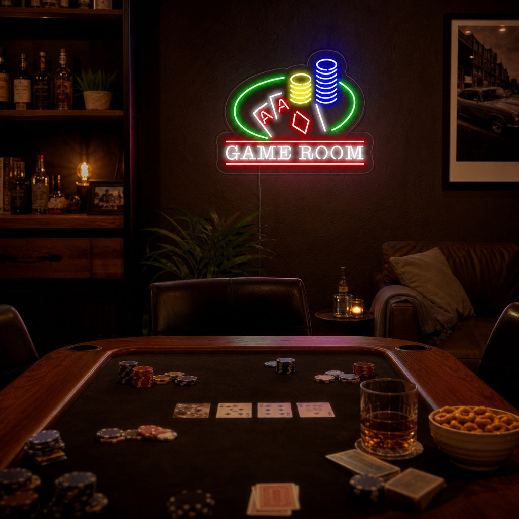 A vibrant neon sign depicting three stacked casino poker chips with a clear acrylic backing, displayed in a well-lit man cave or game room setting, next to a desk and shelves.