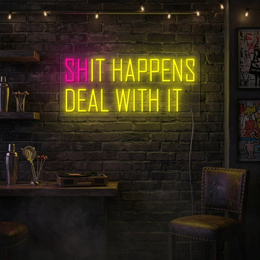 A candid 'Shit happens It happens' neon sign glows on a wall in a relaxed, bohemian-style living room, creating a humorous focal point above a comfortable armchair and next to some leafy plants.