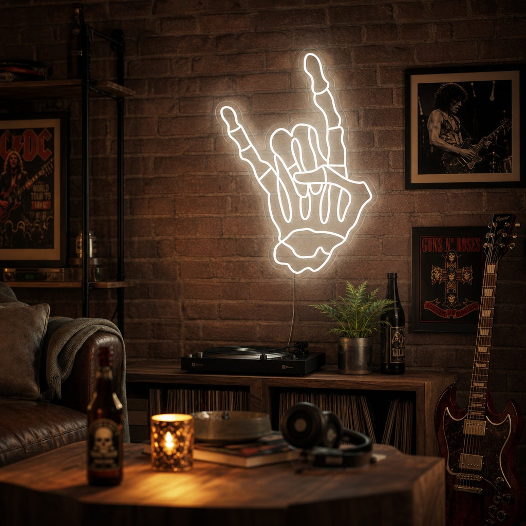 A neon sign mounted on a textured brick wall glows with white and orange light, depicting a skeleton hand making the 'rock on' or rock and roll gesture.