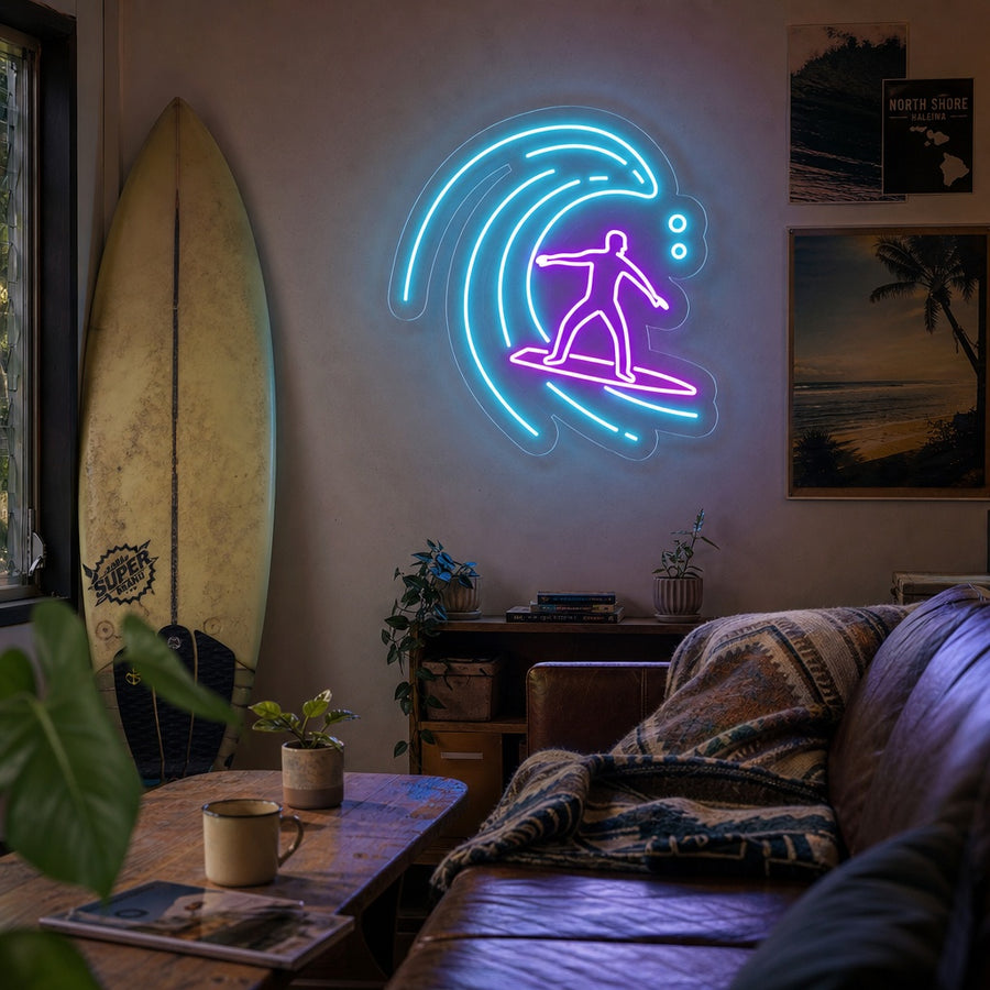 A vibrant neon sign depicting a surfer riding a large ocean wave, glowing blue and yellow against a modern bedroom wall.