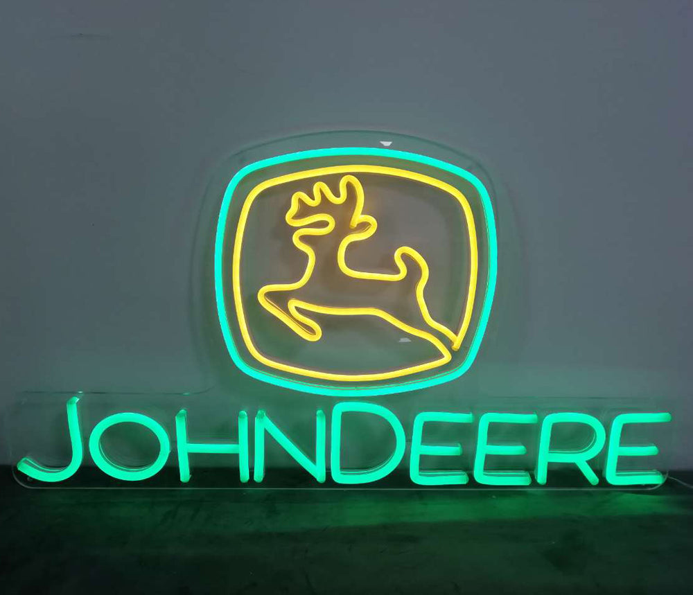 Finished John Deere logo neon sign glowing in green and yellow
