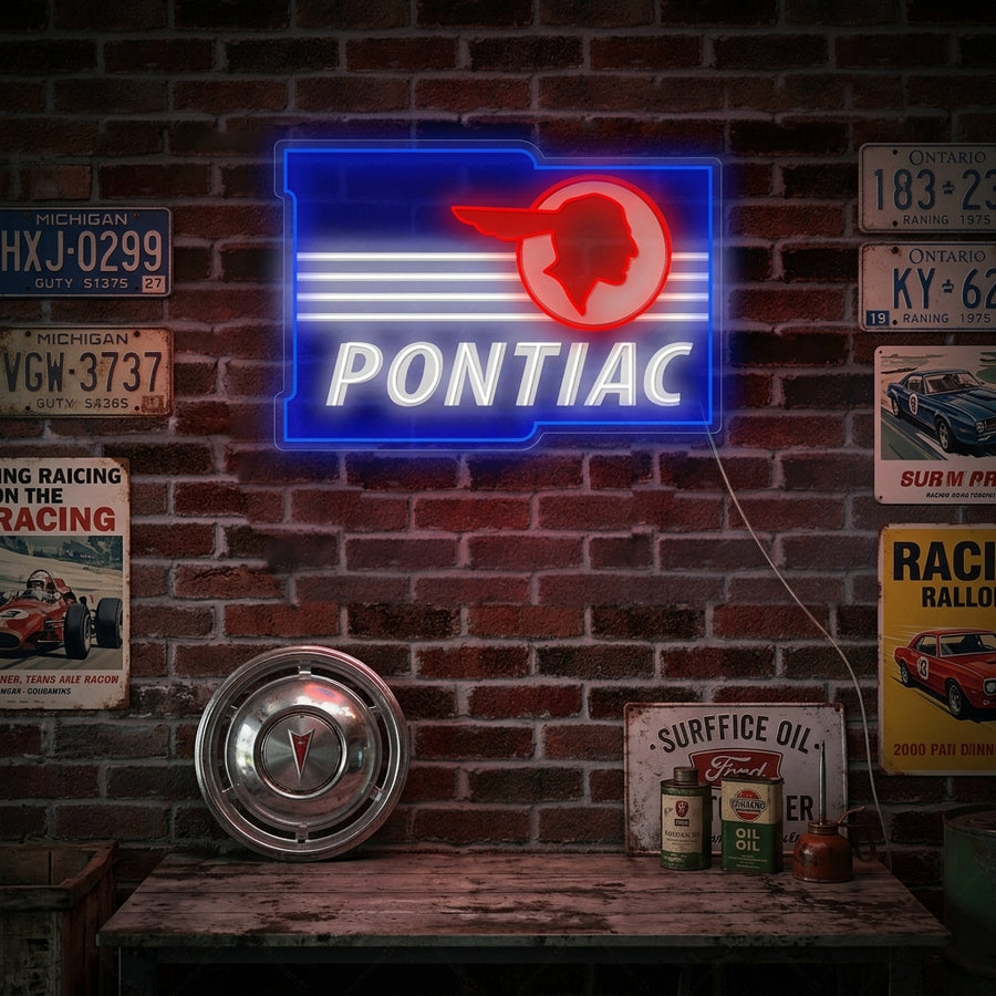 A Ponti-Car neon sign featuring the classic red dart logo and script text, mounted on a dark brick wall within a stylishly decorated garage or man cave, shown glowing.