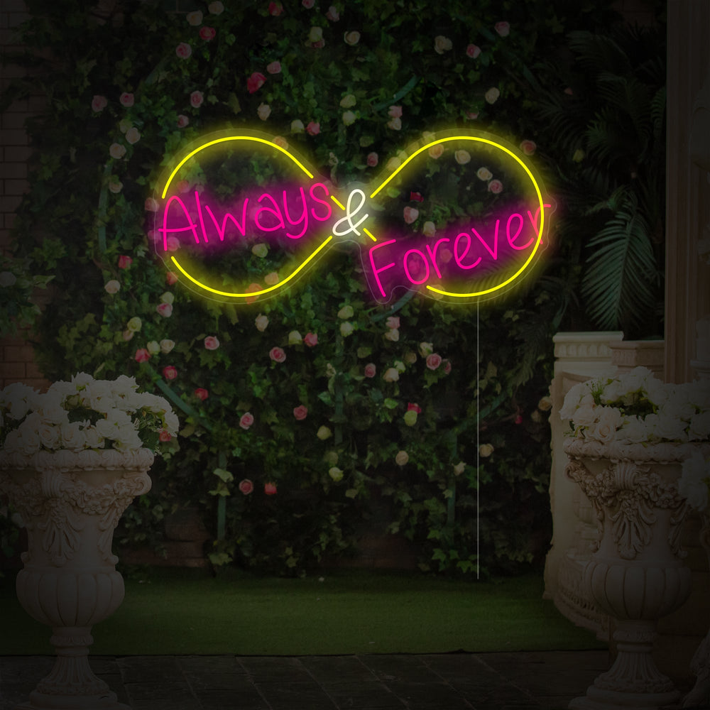 Close-up photograph of an 'Always and Forever' script neon sign mounted on a textured flower wall background.