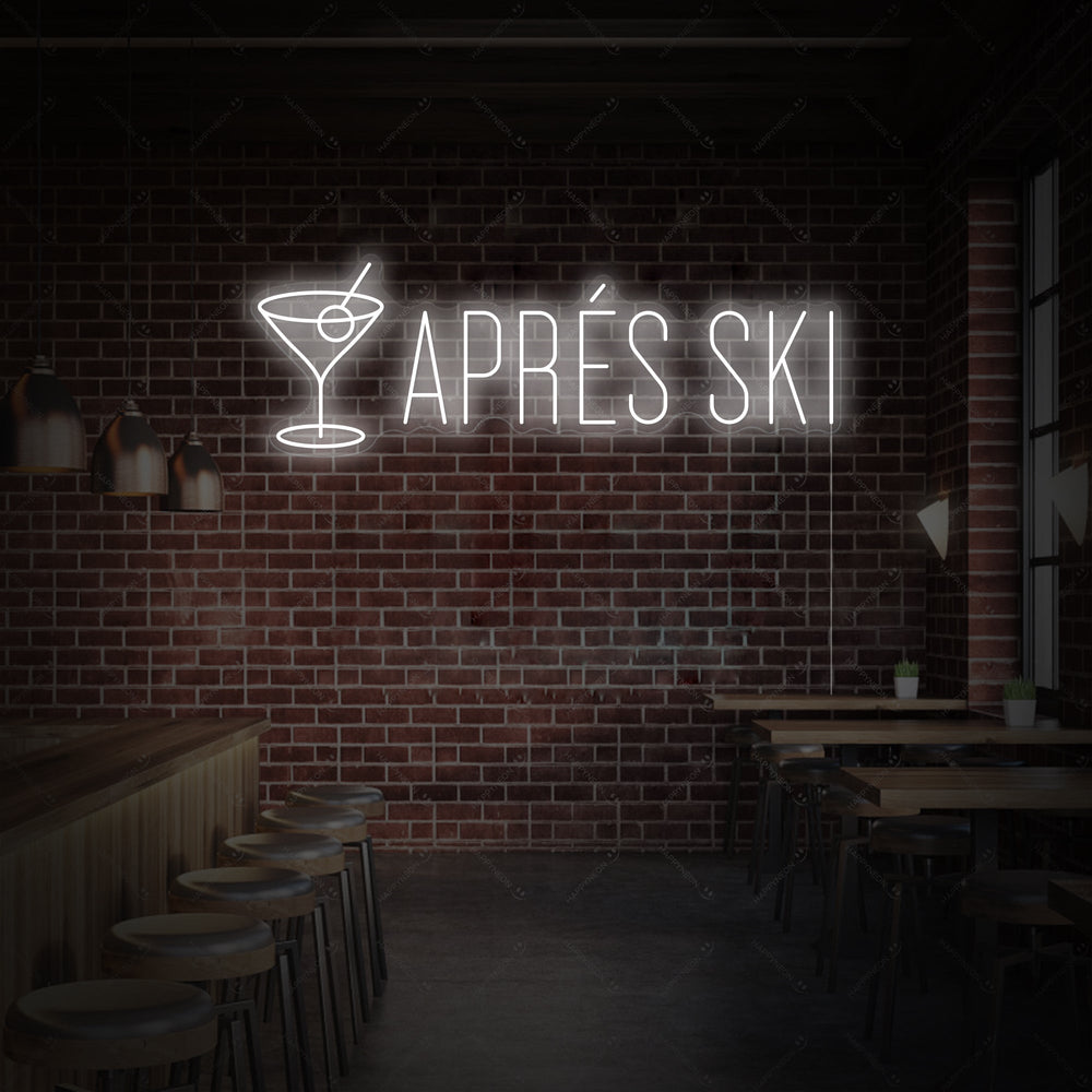A realistic Apres Ski neon sign with a clear acrylic backing, displayed on a textured wooden wall above a cozy home bar setup.