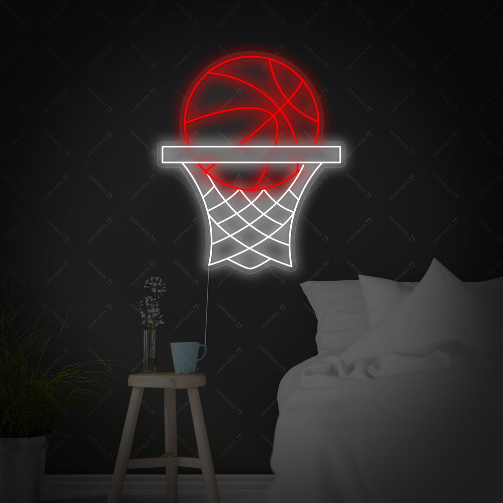 A wide-angle interior view of a contemporary bedroom showing a basketball hoop neon sign glowing vibrantly on the wall directly above the bed, flanked by sports memorabilia.