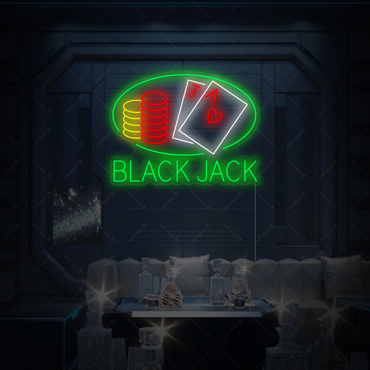 A vibrant Black Jack neon sign featuring cards and chips, mounted on a dark textured wall.