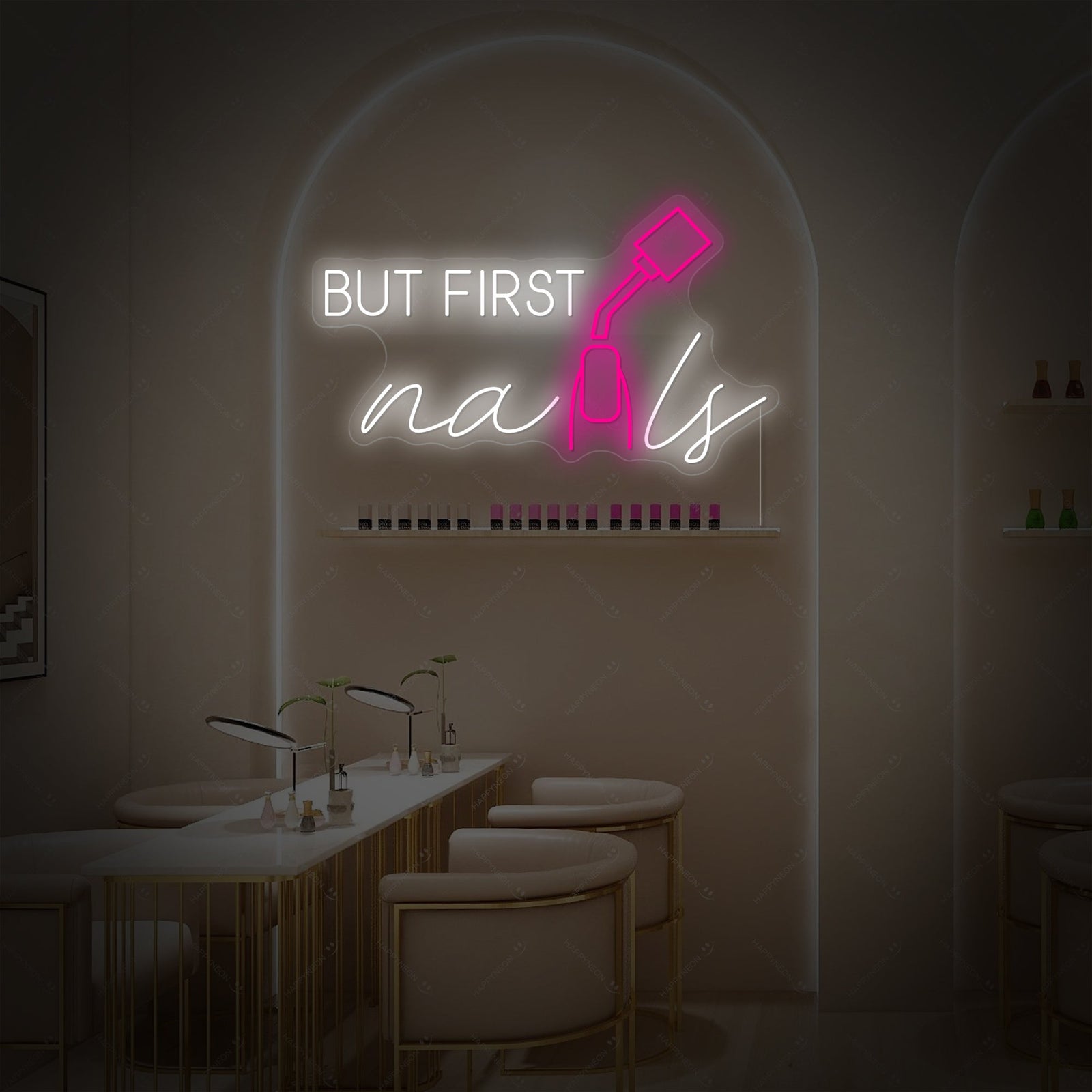 'But First Nails' pink neon script sign mounted on a textured wall.