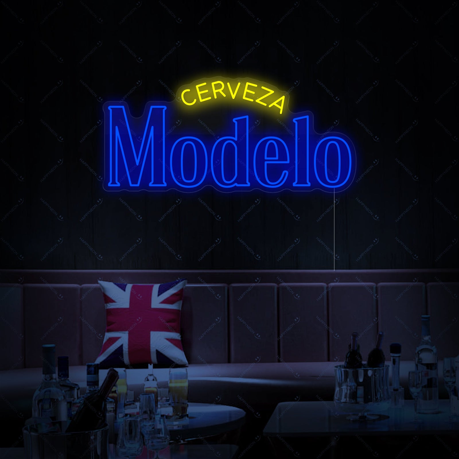 Close-up detailed view of the Cerveza Modelo neon sign, displaying the classic script and blue and gold branding on a dark background