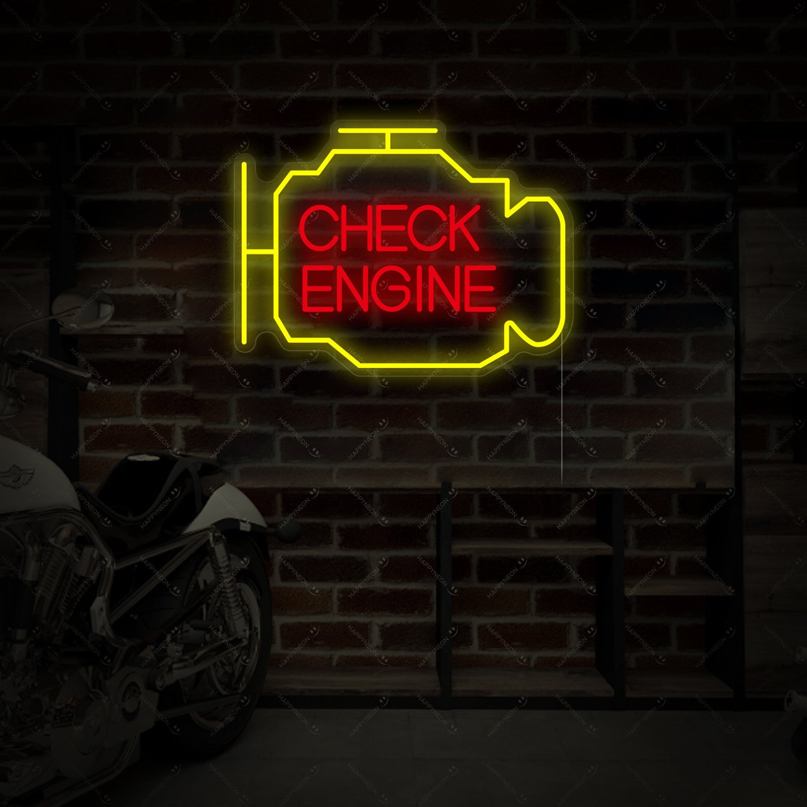 An angled view of an amber 'Check Engine' neon sign mounted on a dark grey brick wall in a garage, with a motorcycle visible in the background.