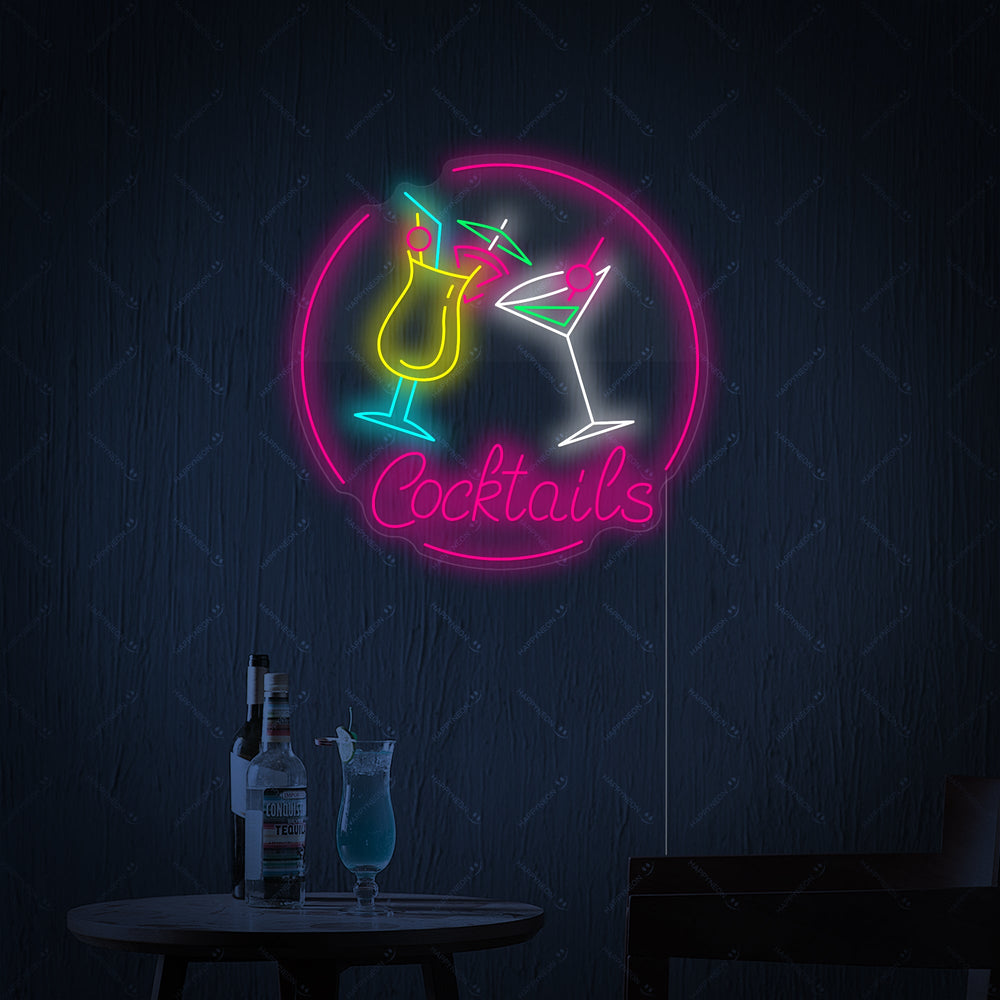 A glowing 'Cocktails' neon sign with stylized pink lettering and a dark outline on a simple background.