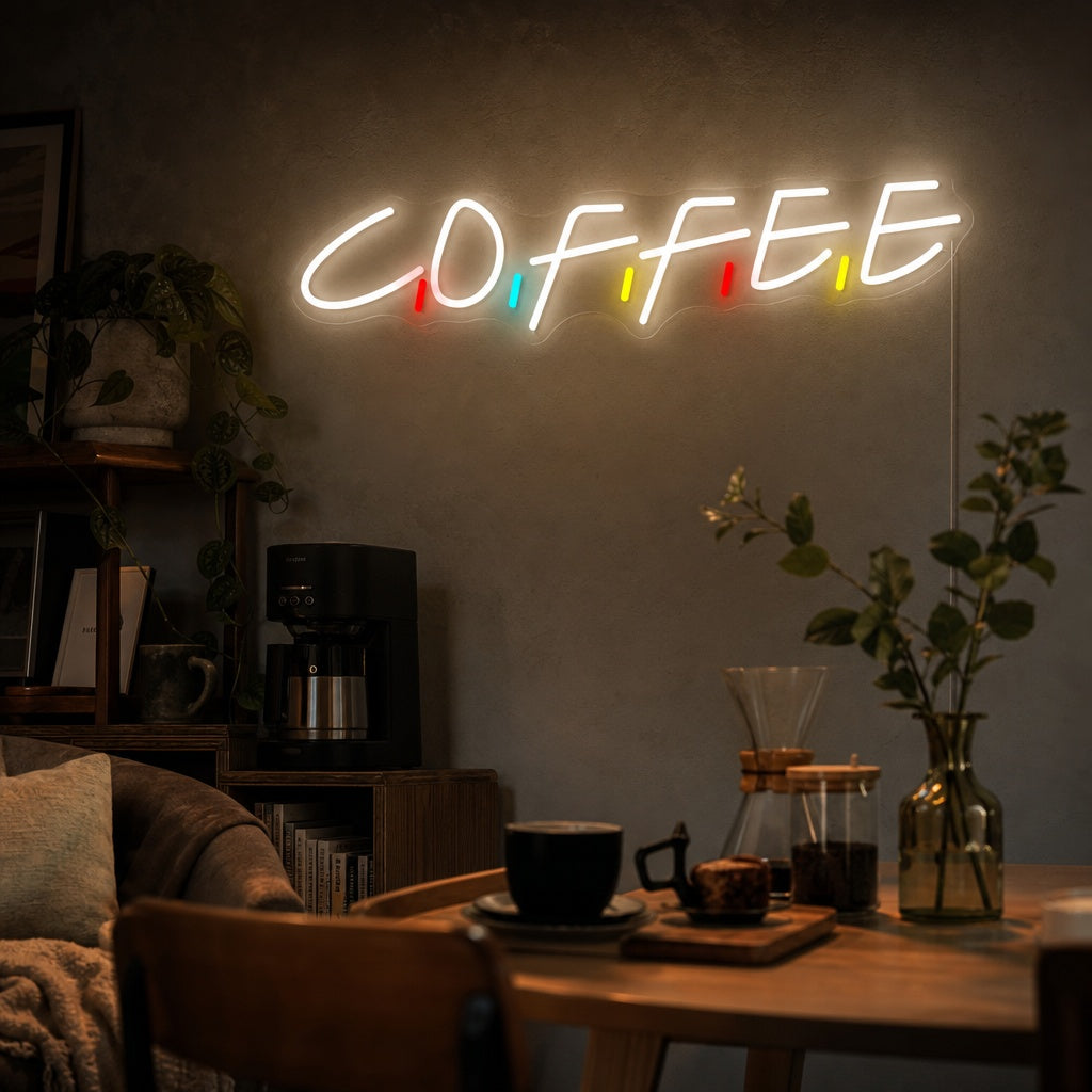 An illuminated white LED 'Coffee' neon sign in a script font, mounted on a brick wall inside a coffee shop environment.