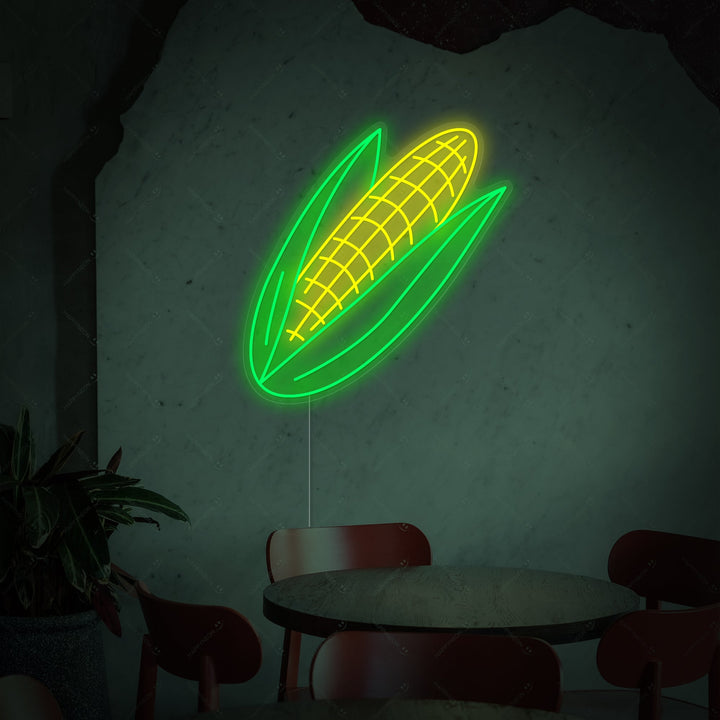 A front view of the 'Corn' neon sign, showcasing the detailed tubing forming the shape of an ear of corn with husks, against a plain background, illustrating the design detail and fabrication.