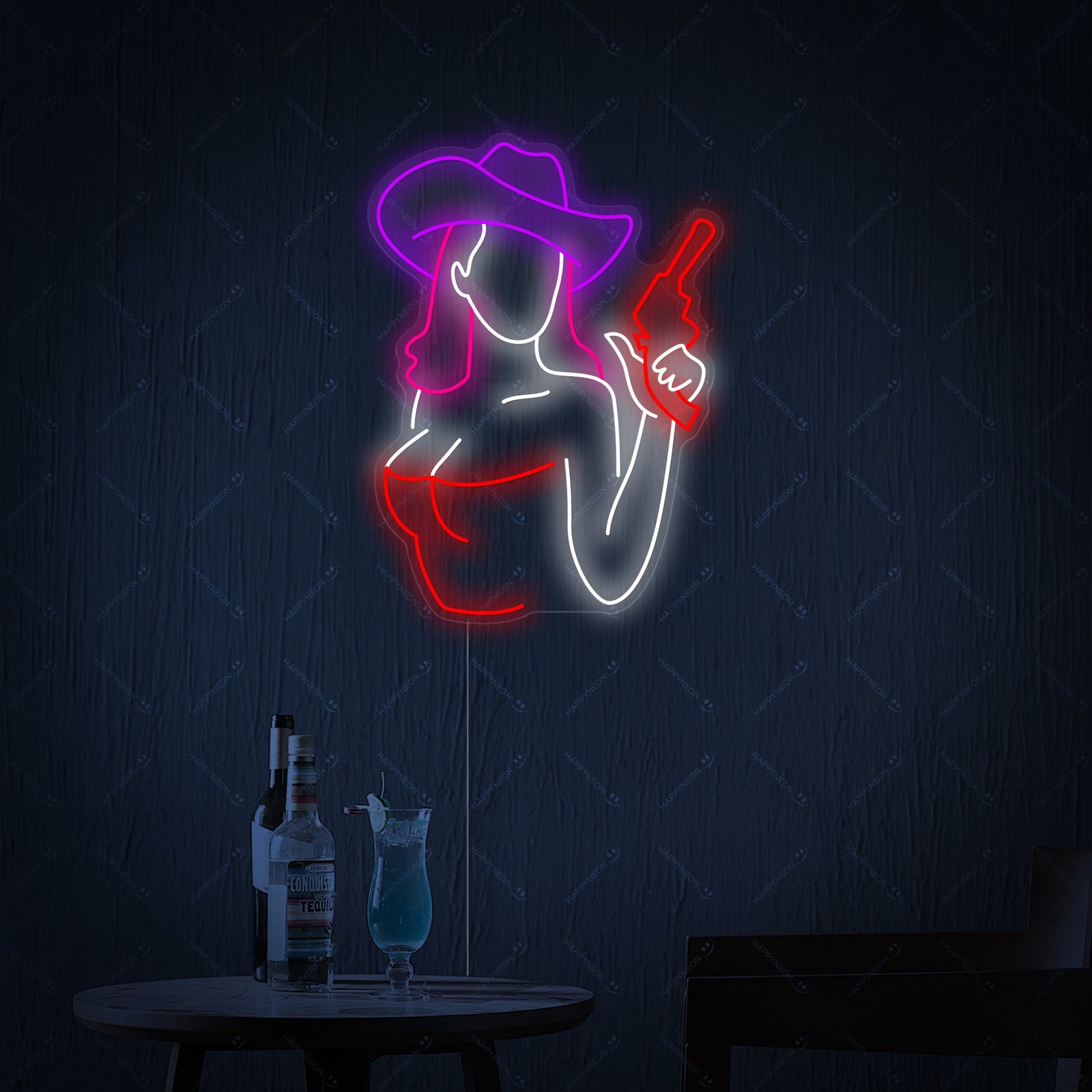 A glowing blue 'Cowgirl Gun' neon sign featuring a cowgirl hat and six-shooters, mounted above a leather sofa in a western-themed room.